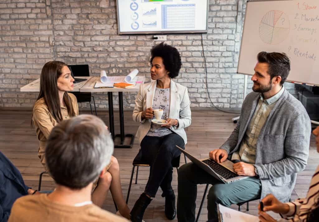 Group of diverse employees sitting in a circle discussing talent development
