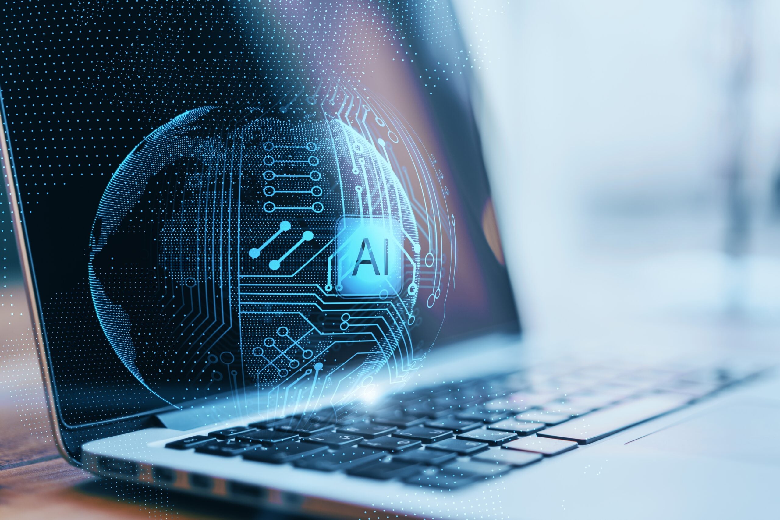 AI visualization of a glowing digital sphere with circuit patterns hovering above a laptop keyboard, representing artificial intelligence technology and data processing.