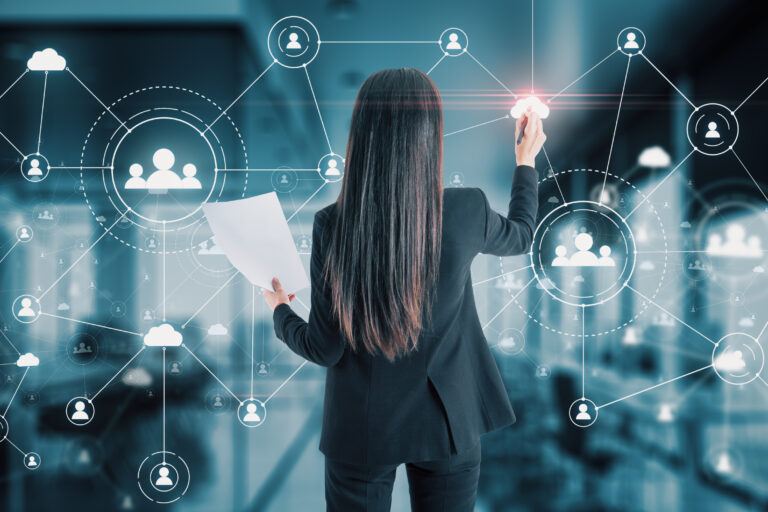 Business professional mapping a connected employee network to represent HR policy rollout and organizational communication