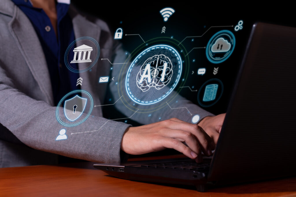 Business professional using a laptop with digital AI, cloud, cybersecurity, banking, and connectivity icons overlaid on the screen.